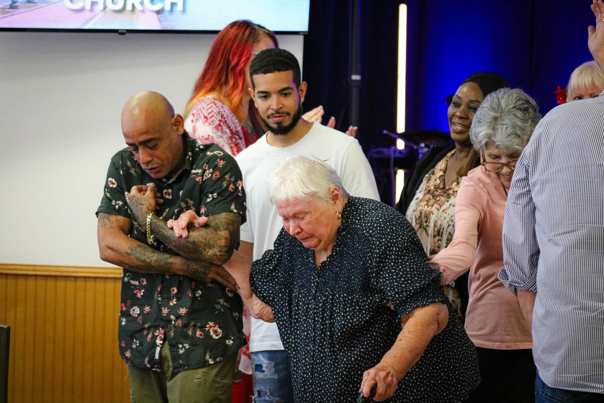 People praying together at Triumphant Church